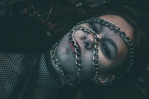A Woman Face Covered with Chains