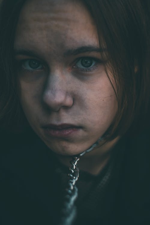 Woman in Black Shirt With Silver Chain Necklace