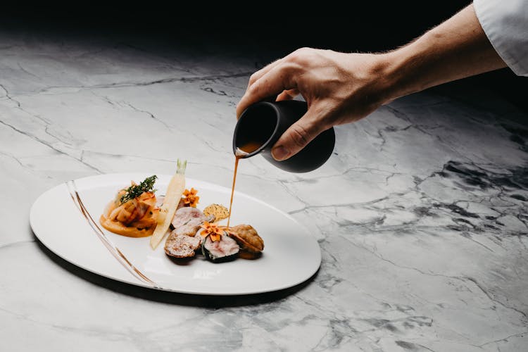 Pouring Sauce On Plated Food