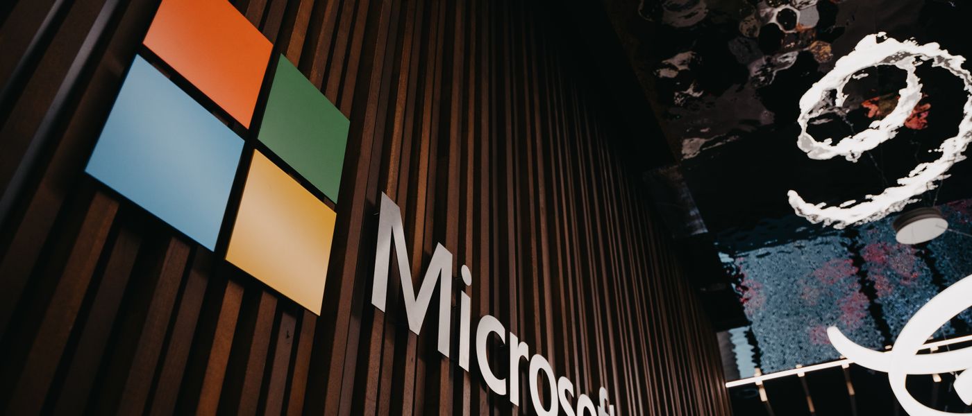 A lock icon superimposed over Microsoft 365 apps, representing robust Microsoft 365 security and zero trust principles against cyber threats.