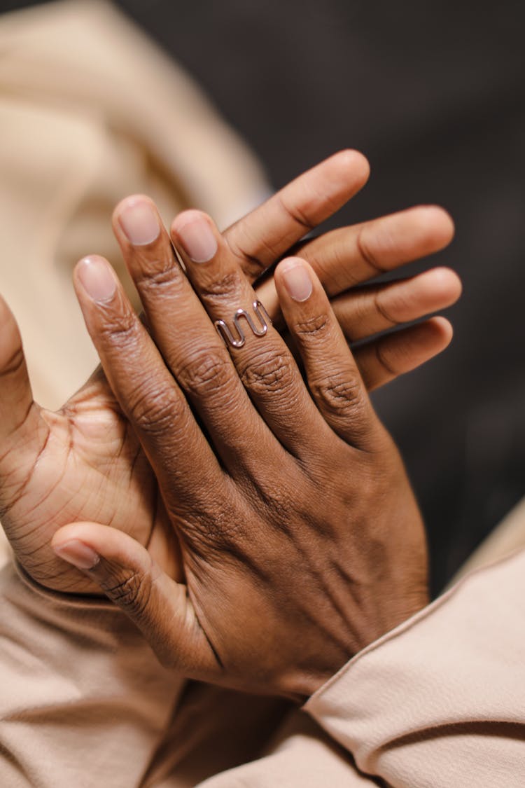 A Person Wearing Silver Ring Clapping Hands