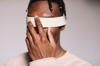Man in White Crew Neck Shirt With White Band on His Left Hand