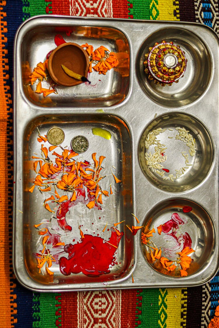 Top View Of A Tray With Food Leftovers On A Patterned Cloth