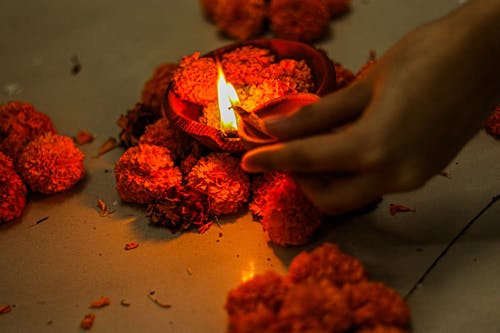 Person Holding Red Candles With Fire