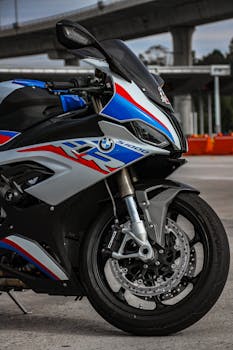 Detailed close-up of a BMW motorcycle outdoors, showcasing its design and structure.