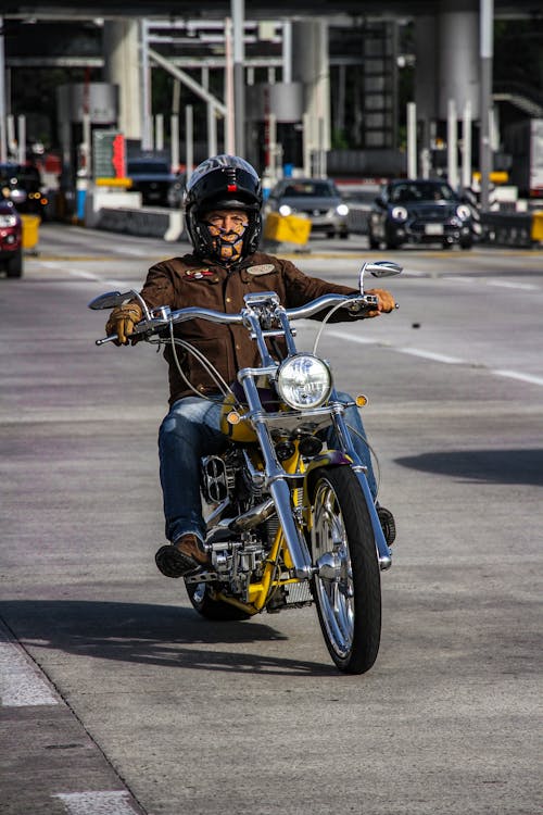 Free Man in Brown Jacket Riding a Motorcycle Stock Photo