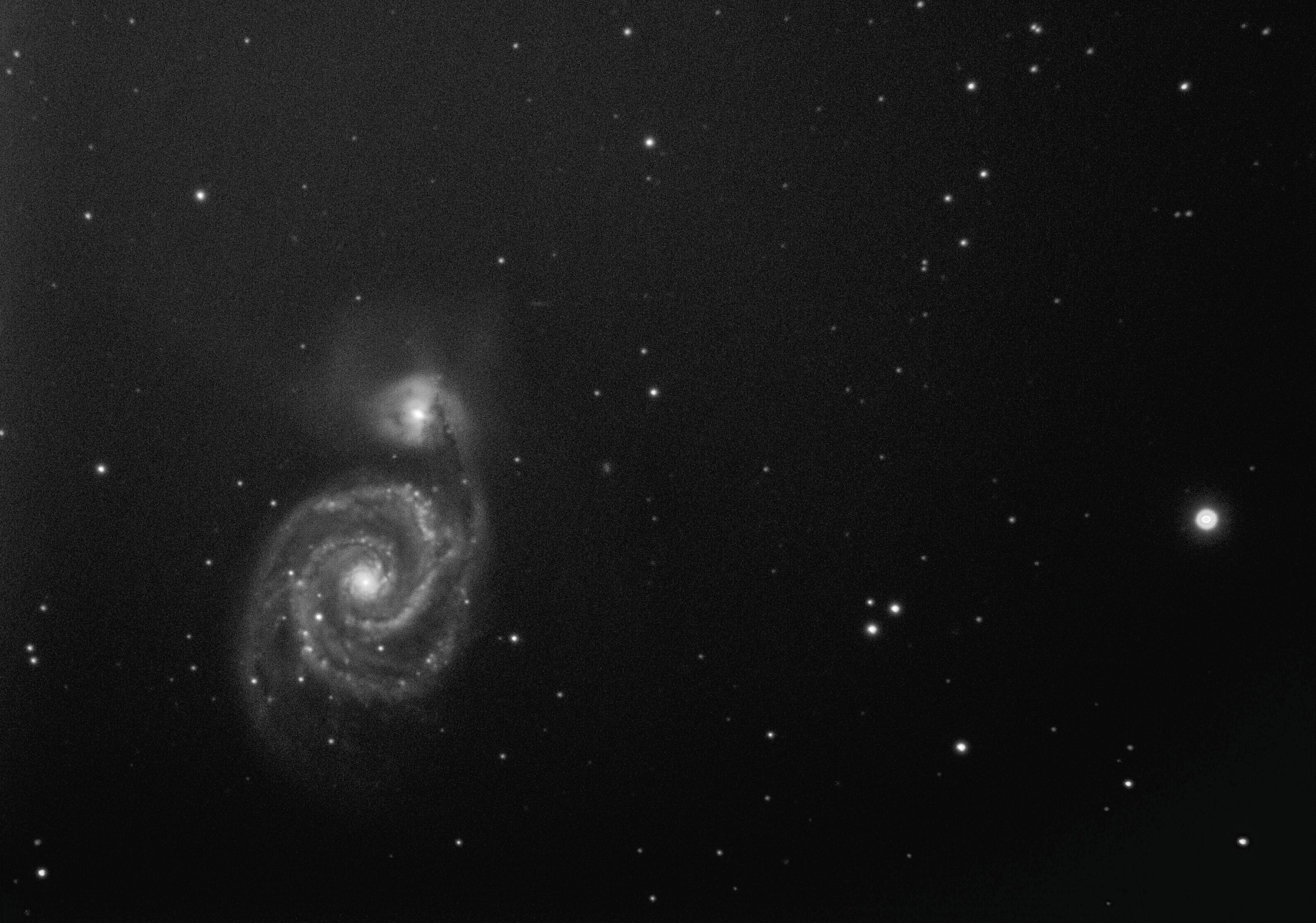 Spiral galaxy with rotating disk showing visible stars against cosmic void
