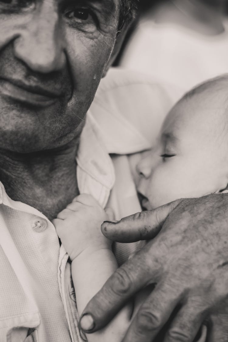 Black And White Portrait Of Man Holding Sleeping Baby