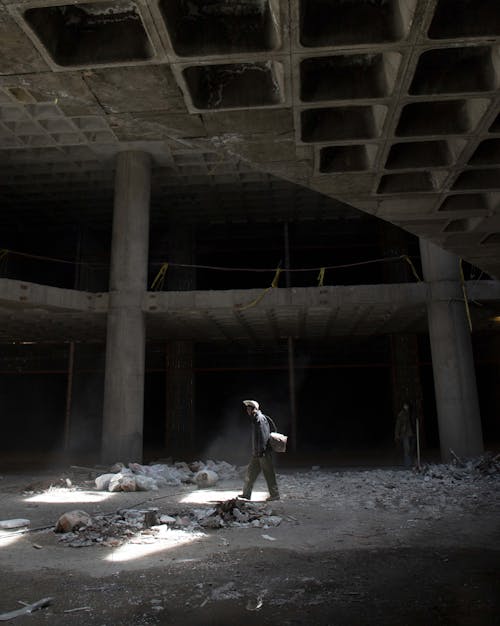 Person Walking Inside an Abandoned Building