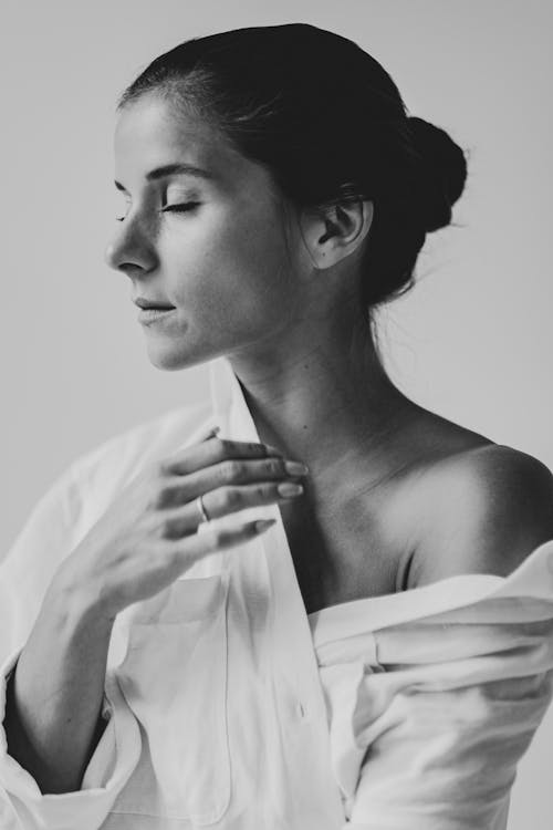 Grayscale Photo of Woman Wearing White Top