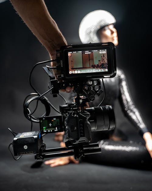 A Person Holding a Black Camera with Screen