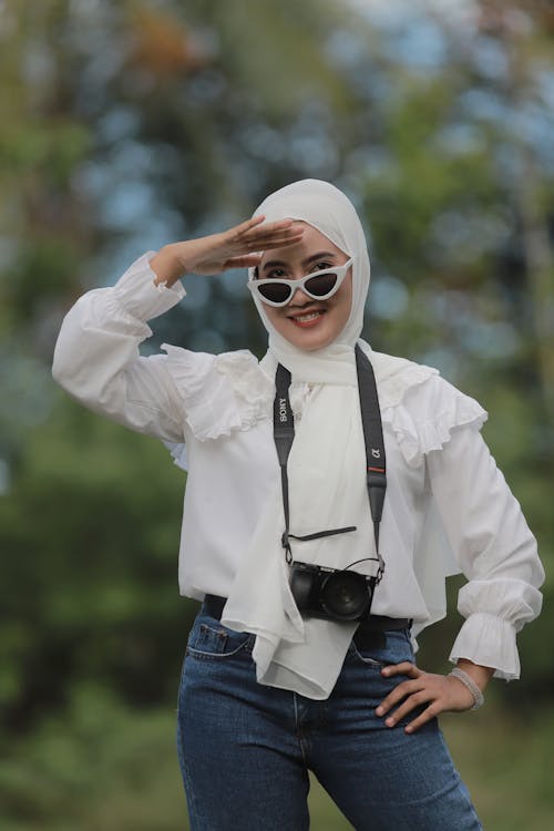 Woman in White Hijab and Blue Denim Jeans Wearing Sunglasses