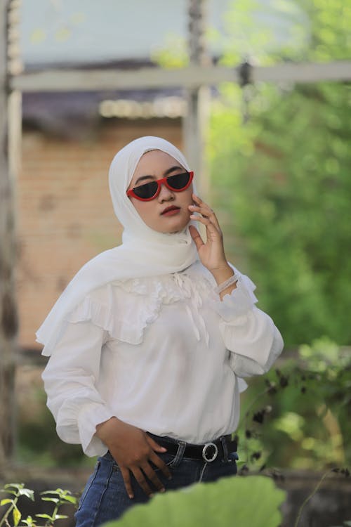 Woman in White Hijab and Blue Denim Jeans Wearing Sunglasses