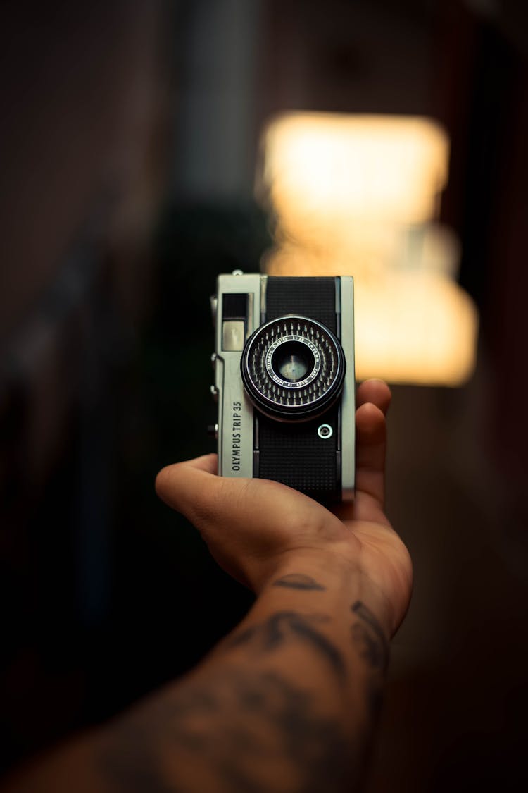 Unrecognizable Male Hand With Tattoos Holding Classic Photo Camera