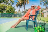 Woman in Red Shirt Sitting on Blue Bench
