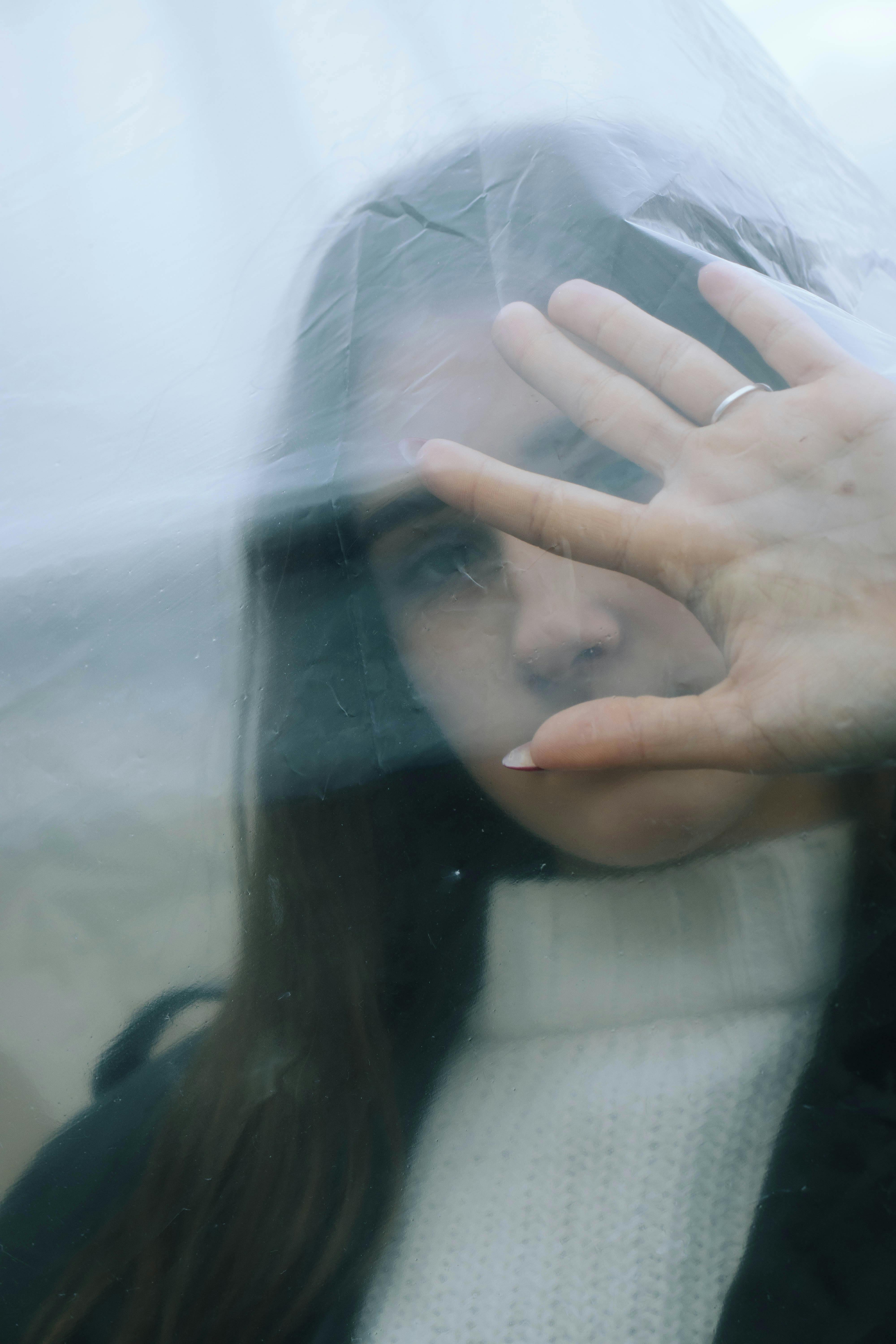 Portrait of Brunette Woman Behind Foil · Free Stock Photo