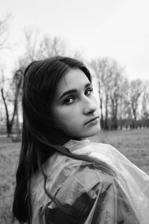 Grayscale Photo of a Woman Looking Back