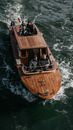 Small Group of People travelling on Motorboat with Wooden Deck 