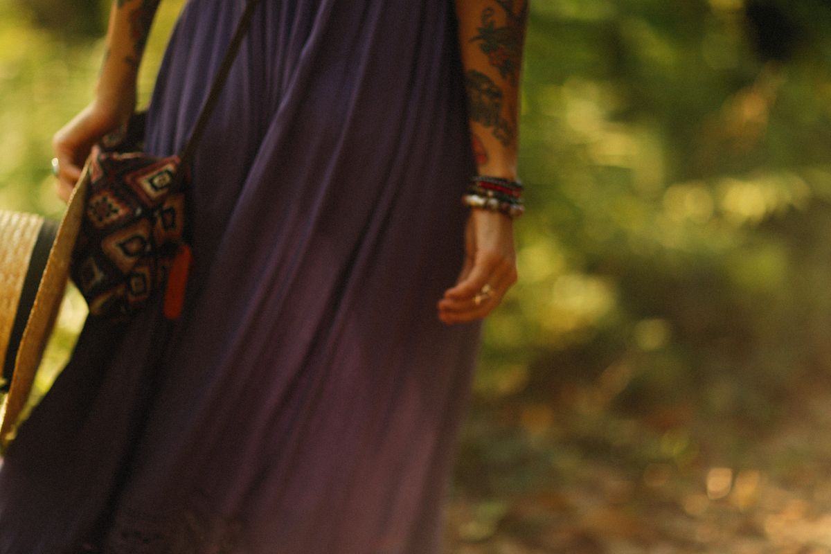 Woman in bohemian dress and jewelry with hat