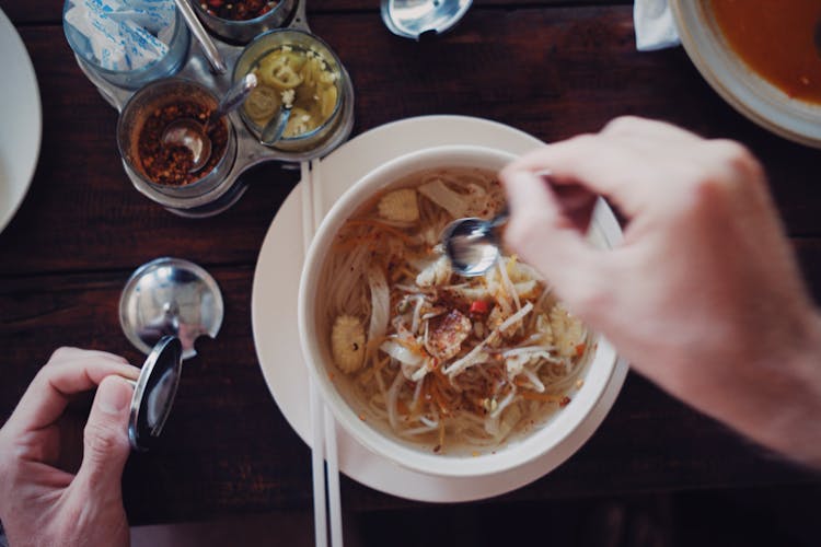 Hands Over Bowl With Soup