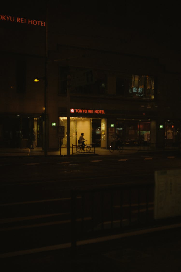 Cyclists In City At Night