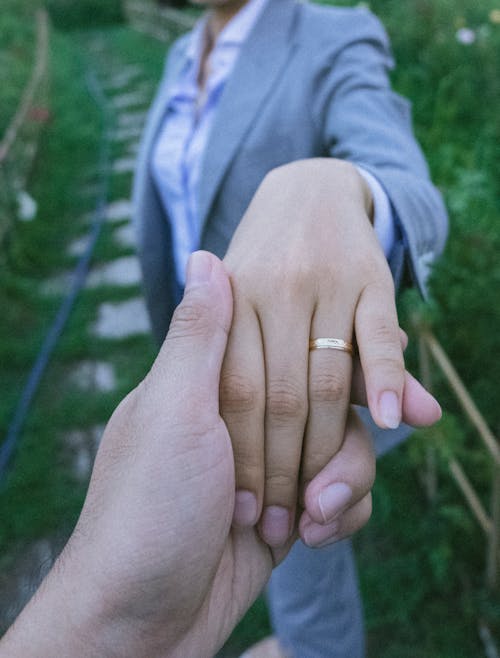 Free Close-Up Shot of Couple Holding Hands Stock Photo
