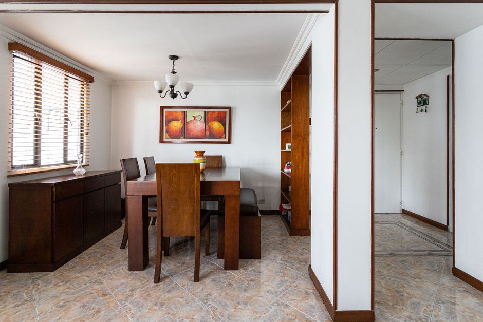 Fotomural Comedor moderno con elegante mobiliario de madera y decoración artística.