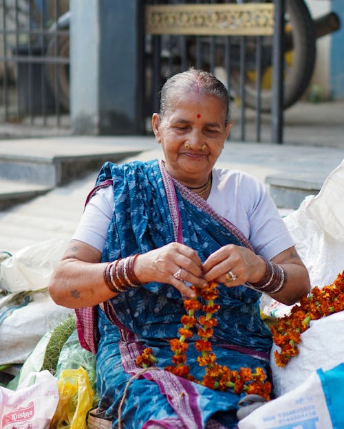 Portrait of Elderly Woman Sitting on Street