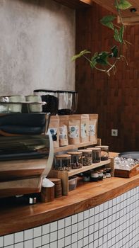 A rustic coffee shop counter displaying various spices and coffee in Bali.