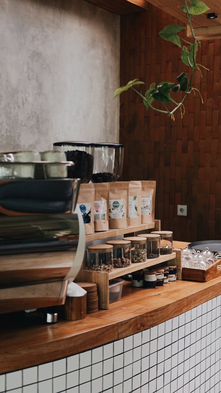 Coffee Beans Spice And Herbs In Glass And Paper Bags And Containers In Coffee Shop