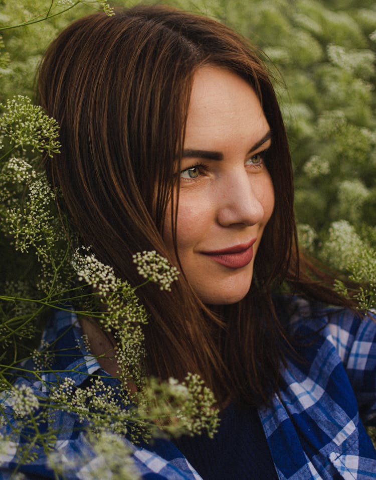 Woman With Brown Hair Sitting In Field Of Cumin Flowers