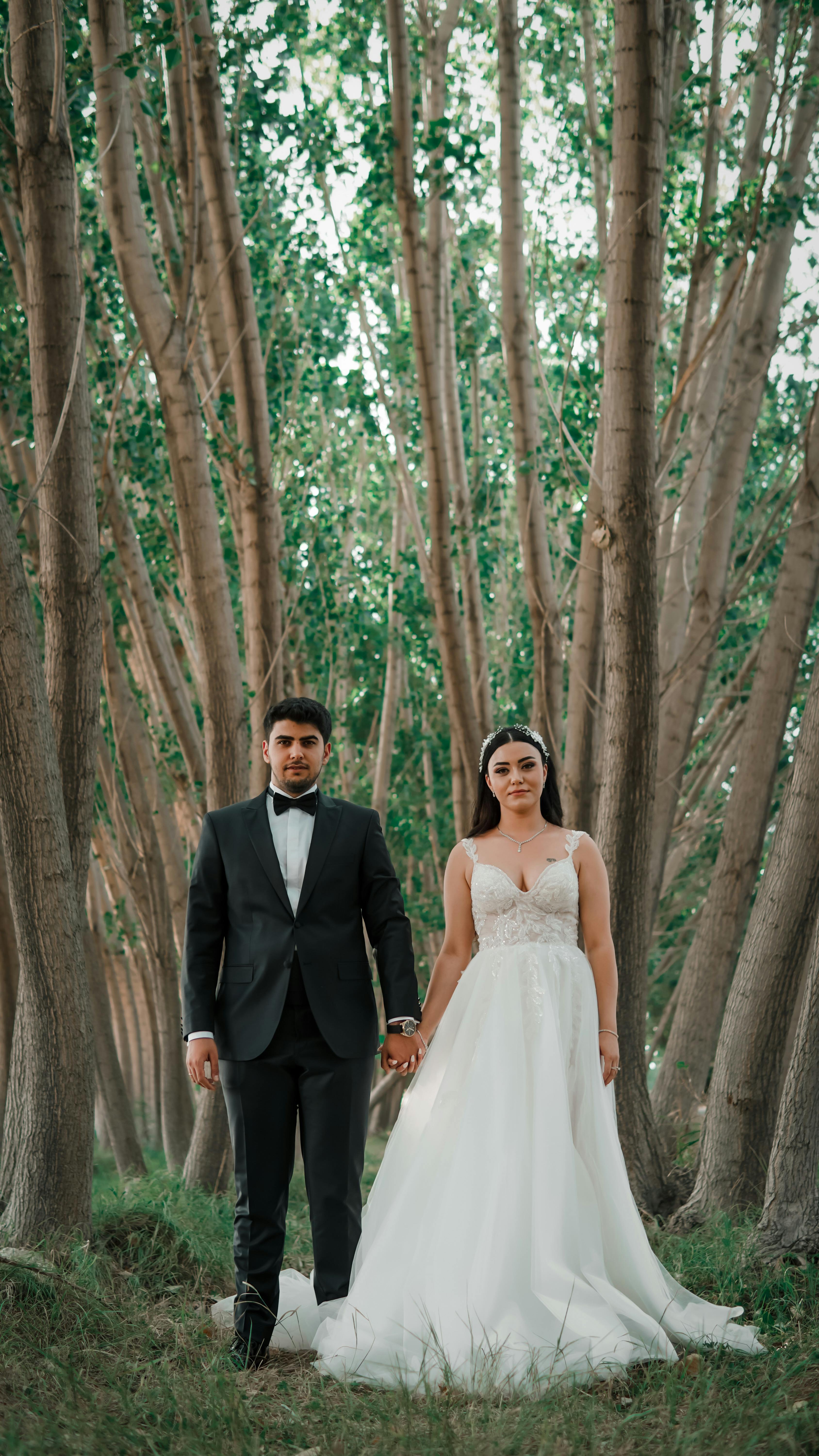 groom and bride in green forest