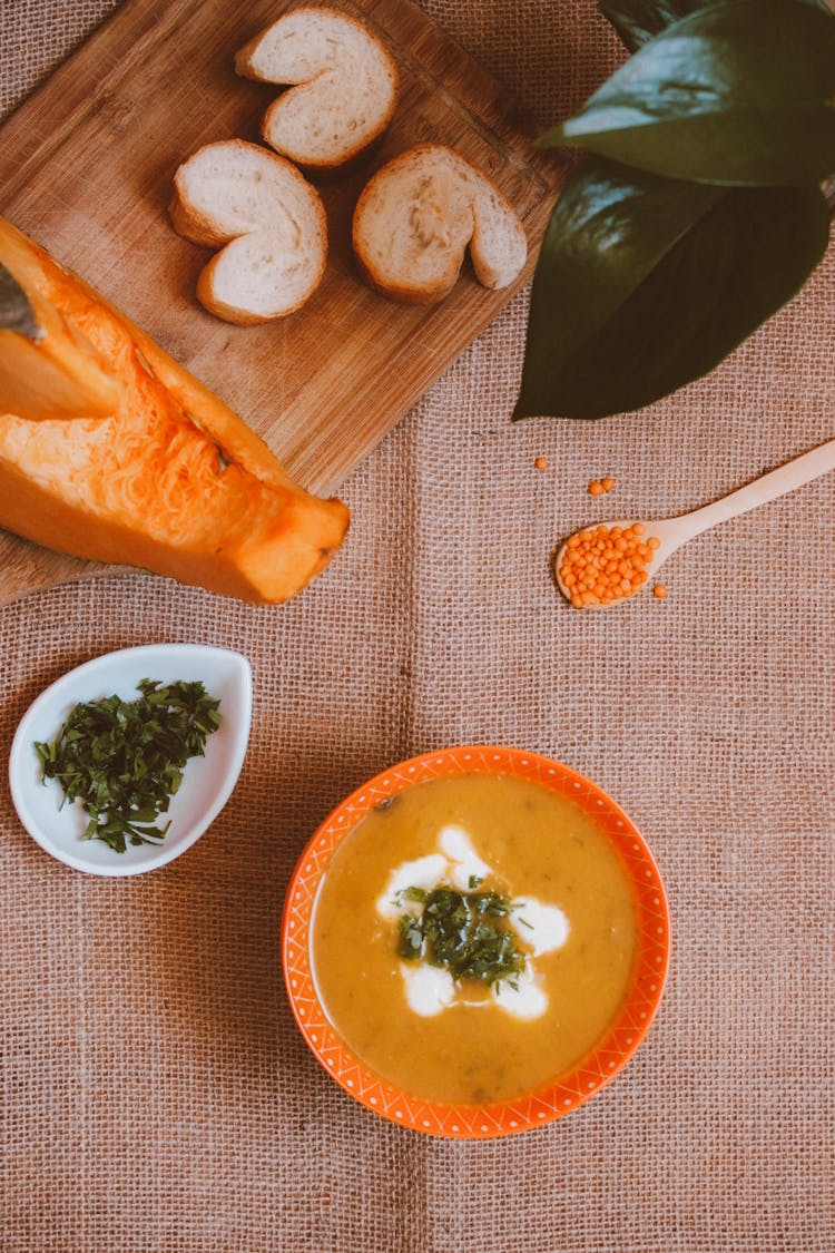 A Flatlay Of A Soup And Bread Slices