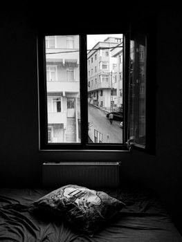 View on Bed by Open Window and Street of Town
