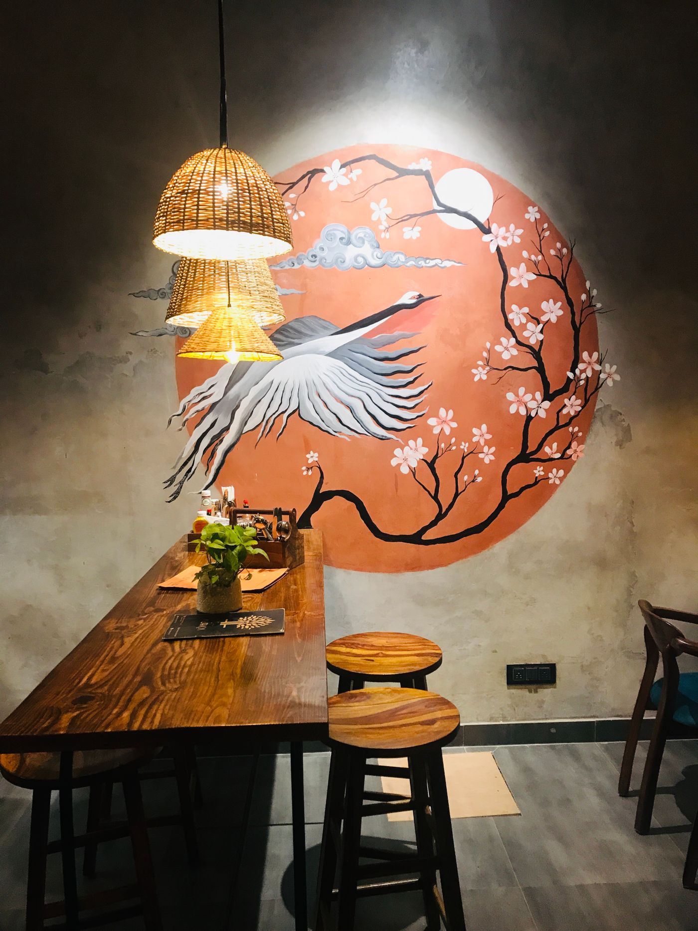 Warmly lit restaurant interior in Gurugram with dining tables and decorative wall treatment