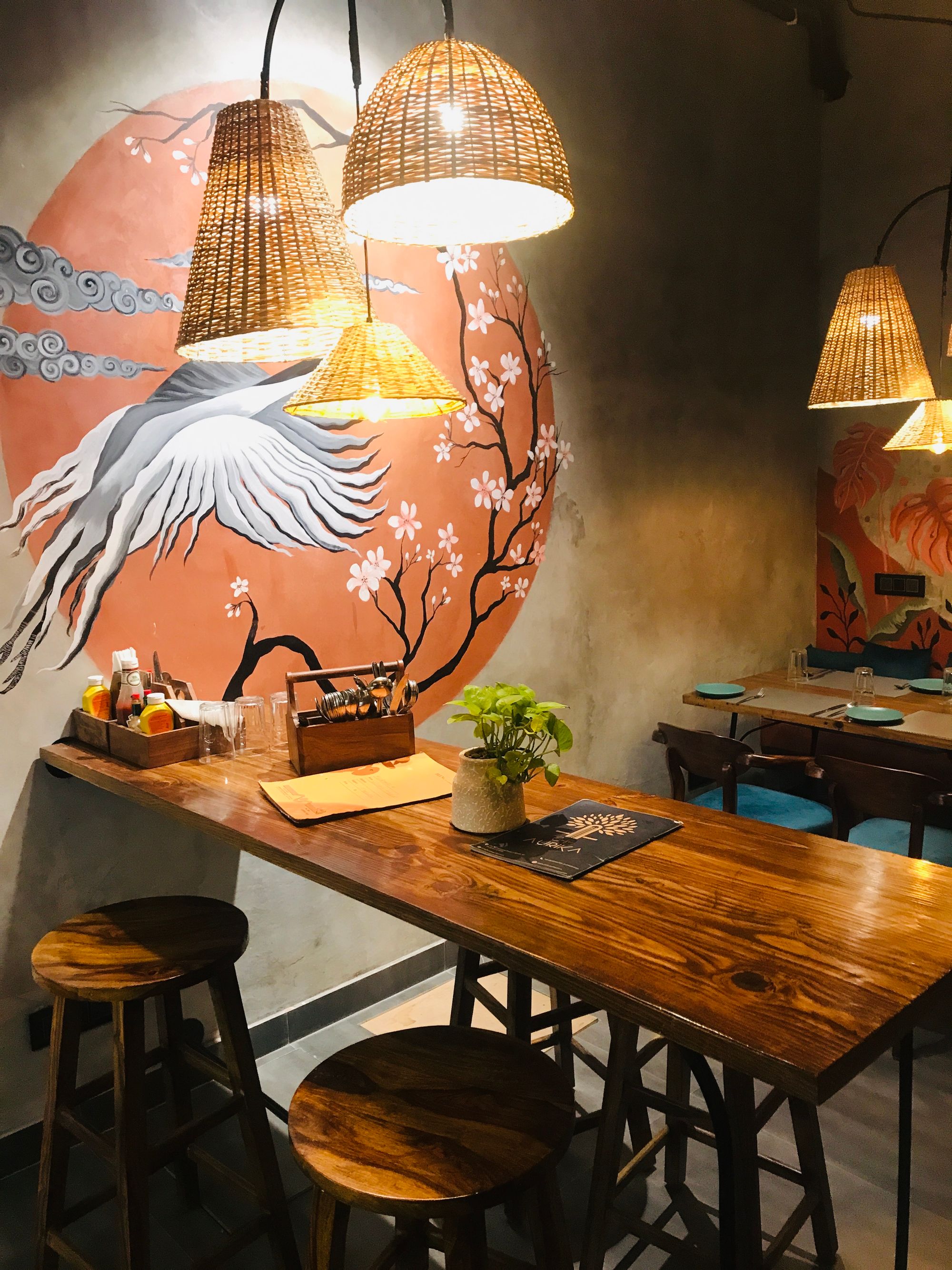 Restaurant interior shaped by a large mural and architectural details