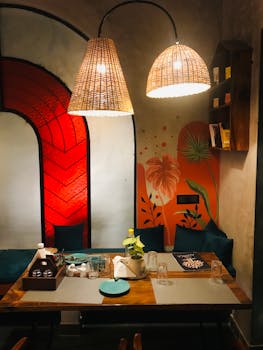 Warm and inviting restaurant setting with unique lighting and colorful mural.