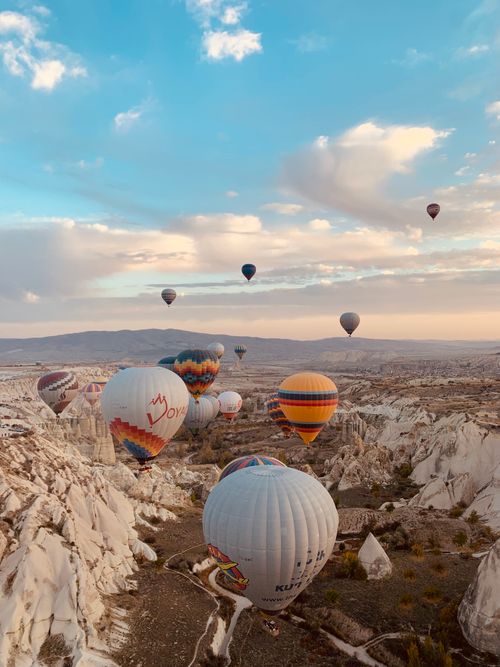 Free Stunning aerial view of colorful hot air balloons over Cappadocia's unique rock formations in Turkey. Stock Photo