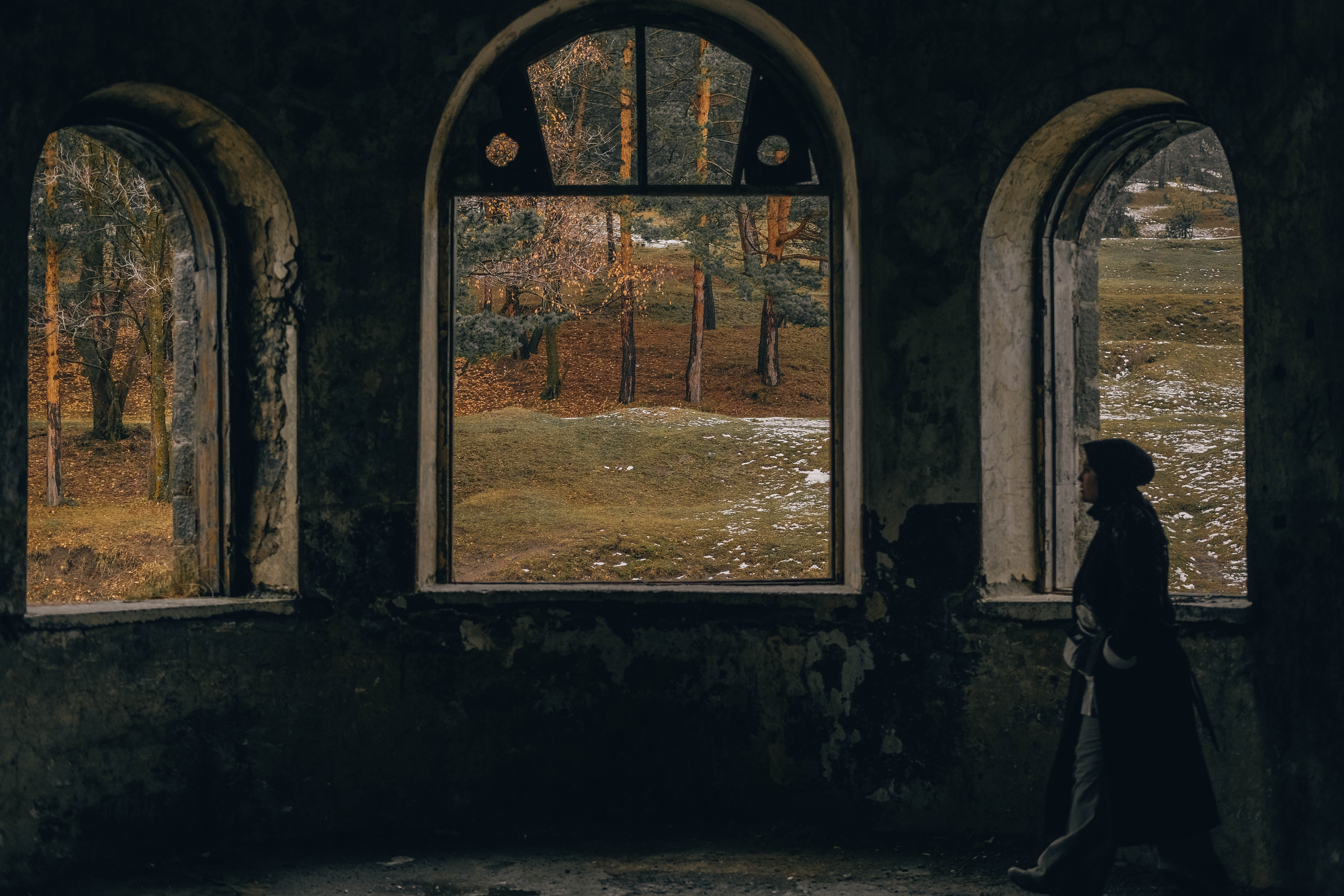 Woman Walking in Abandoned Building near Forest · Free Stock Photo