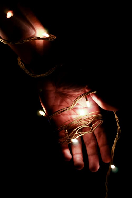 Free A Person with String Lights on the Hand Stock Photo