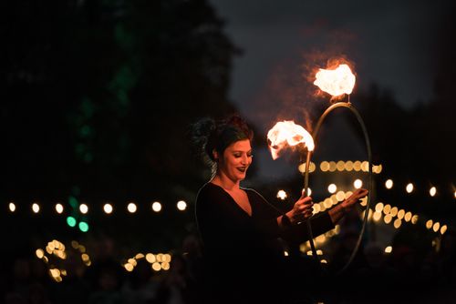 Free A captivating woman performs fire tricks at a nighttime outdoor event. Stock Photo