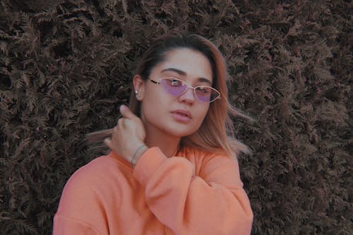 

A Woman Wearing Sunglasses and a Sweater