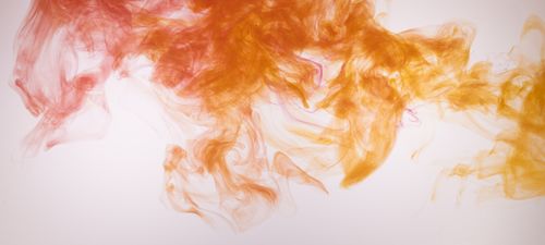 Free Vibrant orange and yellow smoke effect on white background capturing fluid motion and abstract beauty. Stock Photo