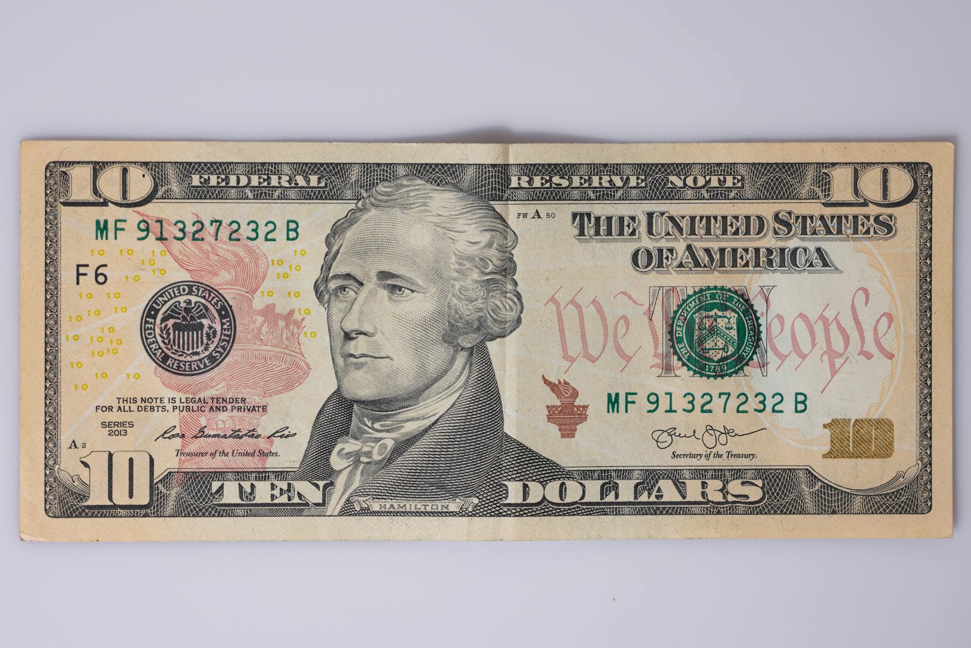 Detailed view of a US ten-dollar bill featuring Alexander Hamilton.