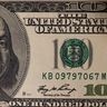 A detailed close-up of a US one hundred dollar bill showing the portrait of Benjamin Franklin.