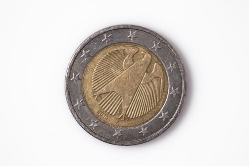 Free A Piece of a Round Coin on a White Surface Stock Photo