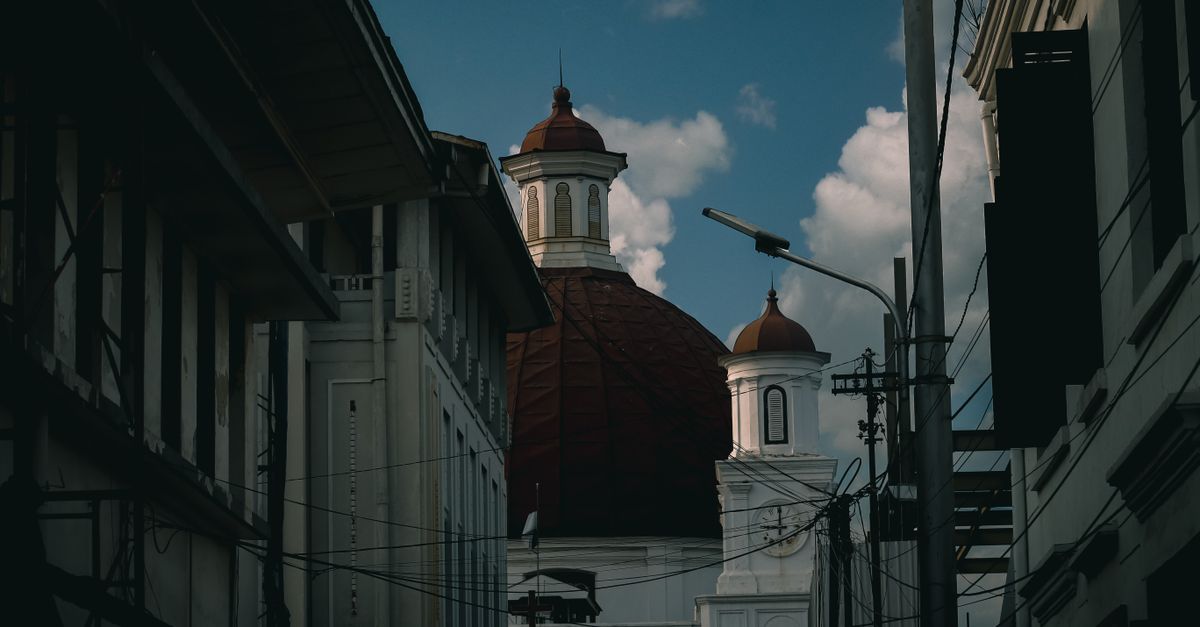 Capture of the iconic Blenduk Church's dome amidst the urban setting of Semarang, Indonesia.