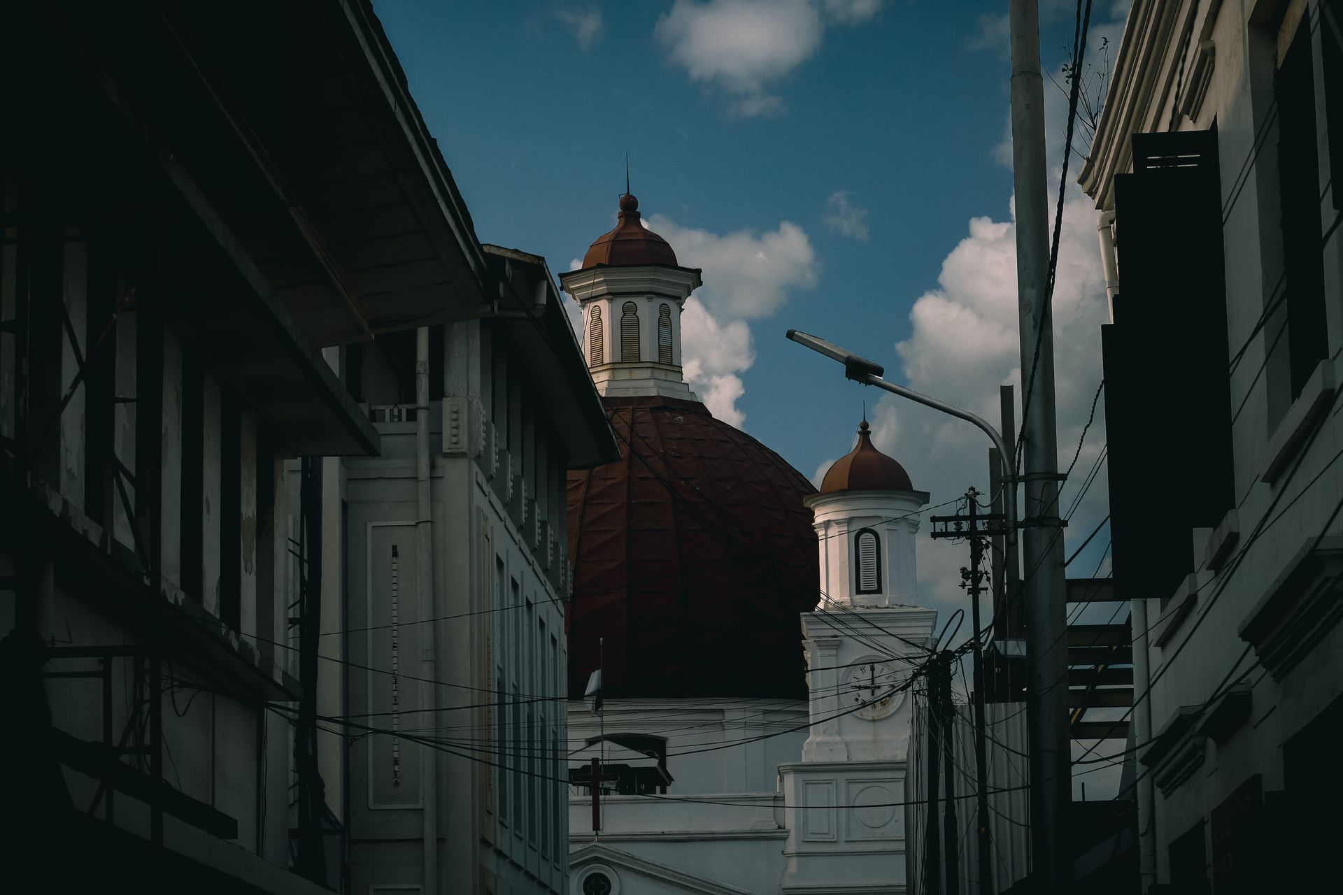 Capture of the iconic Blenduk Church's dome amidst the urban setting of Semarang, Indonesia.