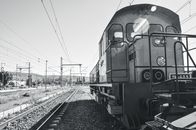 Grayscale Photo of Train on Rail Tracks