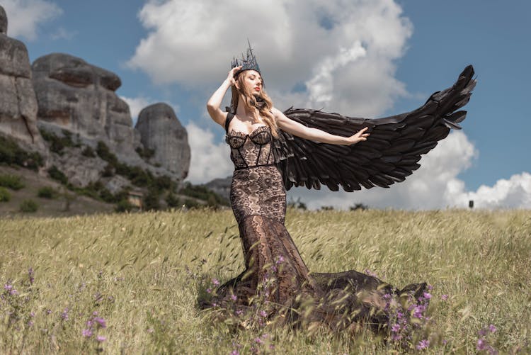 Fashion Woman Model In Black Lacy Dress And Wing